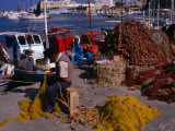 Fisherman Mending His Nets on Waterfront in Herakleion  Greece