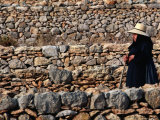 Local Walking Past Rows of Stone Walls  Ibiza  Spain