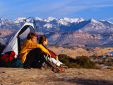 Couple Camping at Slickrock with Snow-Capped Peaks in the Background  Utah  USA