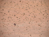 Two Distant People Walking Desert of Wadi Rum  Wadi Rum National Reserve  Aqaba  Jordan