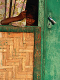 Young Child Peeking Out from Behind Curtain at Watukarare  Sumba  East Nusa Tenggara  Indonesia
