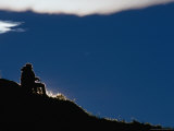 Hiker Lit by the Setting Sun Overlooking Lake Pehoe  Torres Del Paine National Park  Chile