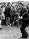 Arnold Palmer Takes a Swing as Crowd Look on Golf