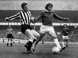 Ollie Burton of Newcastle United Tries to Tackle Alan Ball of Everton During Their Match