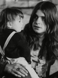 Black Sabbath Lead Singer Ozzy Osbourne Holding a Child