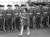 Soldiers Smile as a Lady in Mine Dress and Coat Walks Past Parade Line Up Investiture Rehearsals