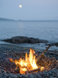 Campfire on a Beach with a Full Moon Visible