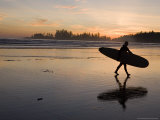 Surfer Walks Across the Beach at Sunset
