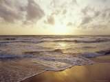 Warm Seas and Waves Roll onto a Tropical Island Beach at Sunset