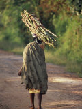 Woman in Local Dress Carries a Bundle of Sticks on Her Head