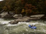 Rafters Riding the Rock Strewn Gauley River Through a Mountain Gorge