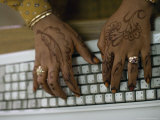 Woman's Hands on a Computer Keyboard Decorated with Henna