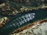 Motorboats Navigate a Channel in the Bay of Puno as a Rowboat Veers Away