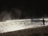 Fly Fisherman Casts For Trout in the Madison River at Dawn
