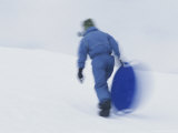 Sledder  Sled in Hand  Climbs a Sun Valley Hill
