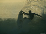 In a Spray of Surf  a Surfer Leaps Up on a Breaking Wave