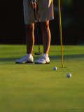 Golfer Putting on a Green in Afternoon Light