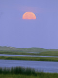 Moonrise over a Wetland with Gentle Rolling Hills in Distance
