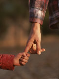 Touching Close-up of a Mother and Daughter Holding Hands