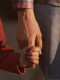 Touching Close-up of a Mother and Daughter Holding Hands