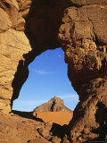 Stone Arch Frames the View over the Desert To a Rock Formation