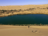 Photographer Bobby Model Skis Down a Large Sand Dune Near the Lake