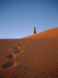 Tuareg Strolls Up a Dune at Sunset  Leaving Footprints in the Sand