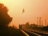 Aerial Crop Duster and Train at Sunrise