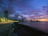 Twilight View of Young Cubans Sitting on City's Seawall