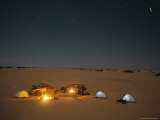 Campfires Burn Next To Tents and Cars at a Campsite in the Desert