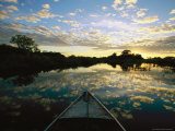 Clouds Reflecting on Waters' Surface at Twilight with Bow of Boat