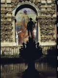 Mural Depicting Neptune on a Wall Near a Statued Fountain