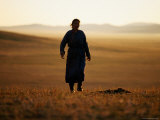 Mongolian Woman Walking across the Steppe at Sunrise