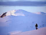 Snowboarder Walking on Slopes During Midnight Sun