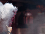Worshipper with Handful of Incense Sticks at Darma Jaya Temple During Chinese New Year