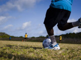 Torres Strait Islander Boy Taking a Goal Kick During a Soccer Game