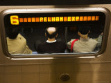 Overhead of Passengers Framed by Window of Train Carriage