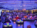 Teenagers Ride Bumper Cars under Neon Blue Lights