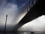 Ferry Travelling Underneath the Harbour Bridge in Fog