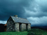 Storm Clouds Pass over a Bluestone Cottage in the Scottish Highlands