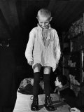 A Little Boy Receiving a Pair of New Boots and Clothing from Swiss Relief Workers