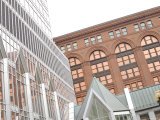 Modern Glass Building and Historic Brick Building in City