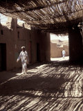 White-robed Man Walks under Thatched Canopy  Morocco