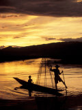 Intha Fisherman Rowing Boat With Legs at Sunset  Myanmar