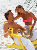 Couple Relaxing on Beach with Lounge Chairs