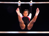 Young Female Gymnast on the Uneven Bars