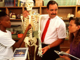 Students with Teacher Examining Skeleton in 7th Grade Science Class