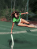 Woman Leaping over the Net on Tennis Court