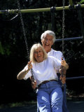 Healthy Couple in Park on Swing
