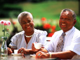 Retired African-American Couple Eating Together at Outdoor Cafe